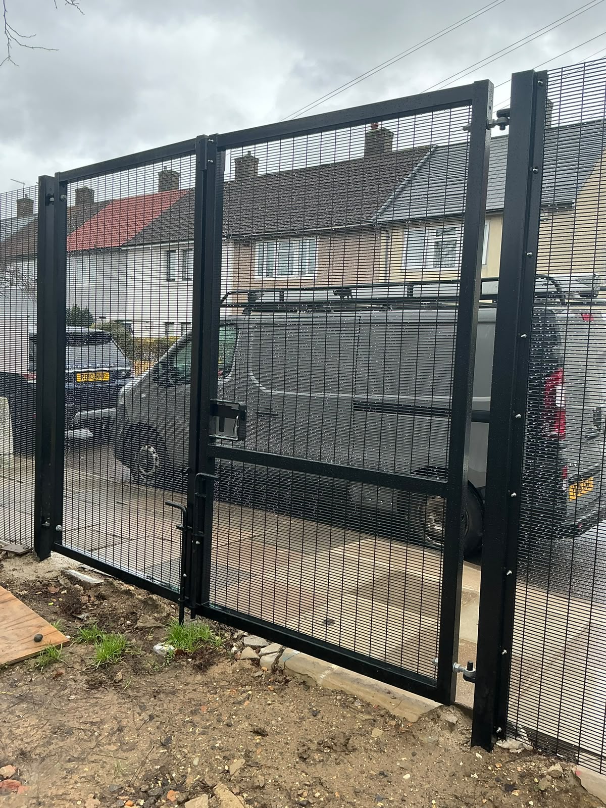 Black high-security 358 mesh double gates at a residential boundary