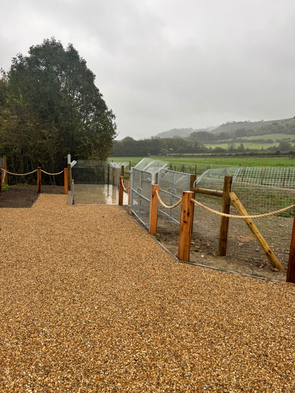 Timber posts with rope edging alongside mesh duckboard fencing