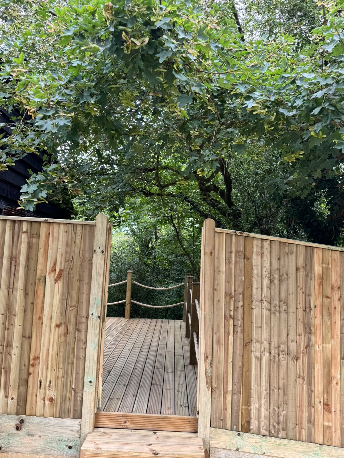 Decked platform enclosed with picket fencing and a matching gate