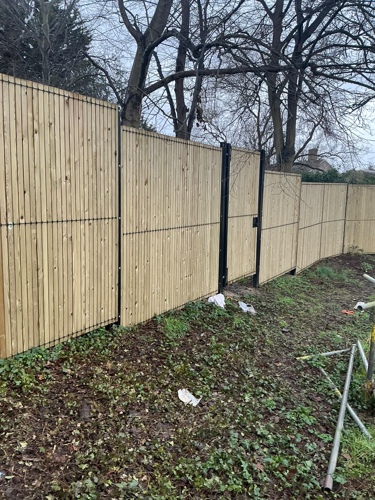 Vertical slat fencing with matching gates built into the run
